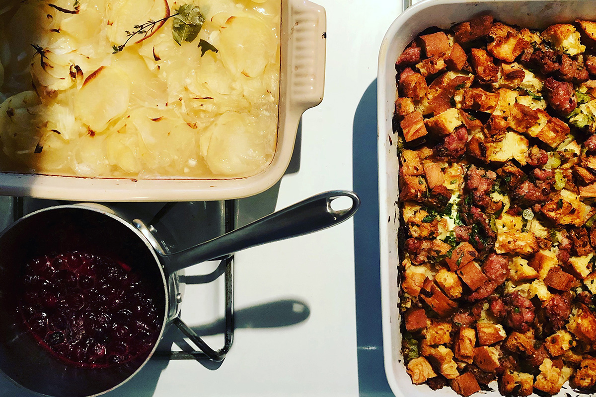 overhead shot of mashed potatoes, stuffing and cranberry sauce